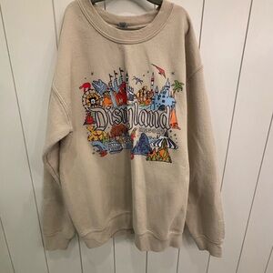 Beige Crewneck Sweater with Vibrant Graphic Design